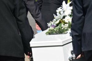 Casket being carried at funeral. Who can file a wrongful death lawsuit in Georgia?