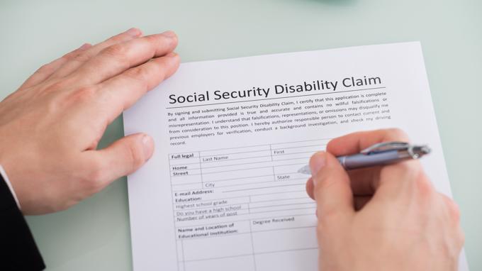 A person filling out an SSDI form.
