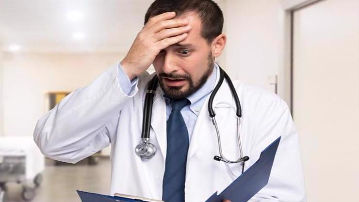 A doctor reading a chart realizes he made a mistake