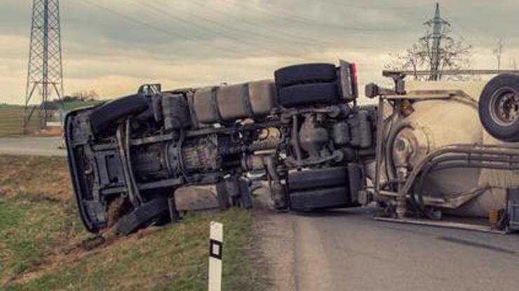 A tractor-trailer turned on its side from an accident.