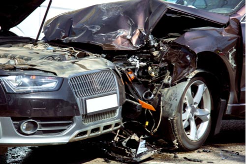 Head-on collision of two cars, close-up of damaged cars