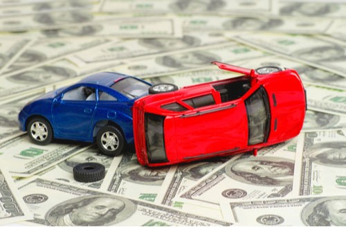 Car accident settlement toy cars crashed on money