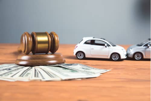 Concept of Wilmington car accident lawyer cost toy cars gavel money