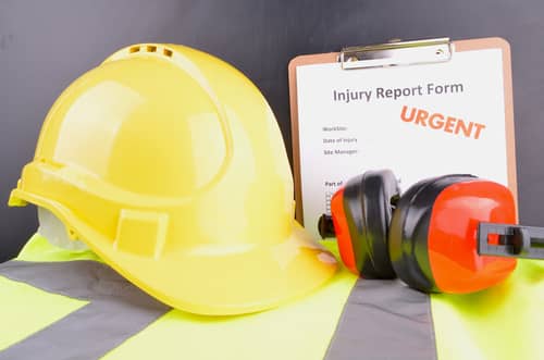 Hard hat and form for workplace injury in Wilmington