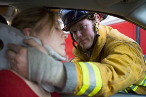 Catastrophic Injury Lawyer Charlotte, NC with firefighters helping an injured woman in a car