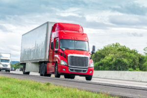 Truck Accident Lawyer Charlotte, NC - Red Eighteen Wheeler Travels Interstate Highway